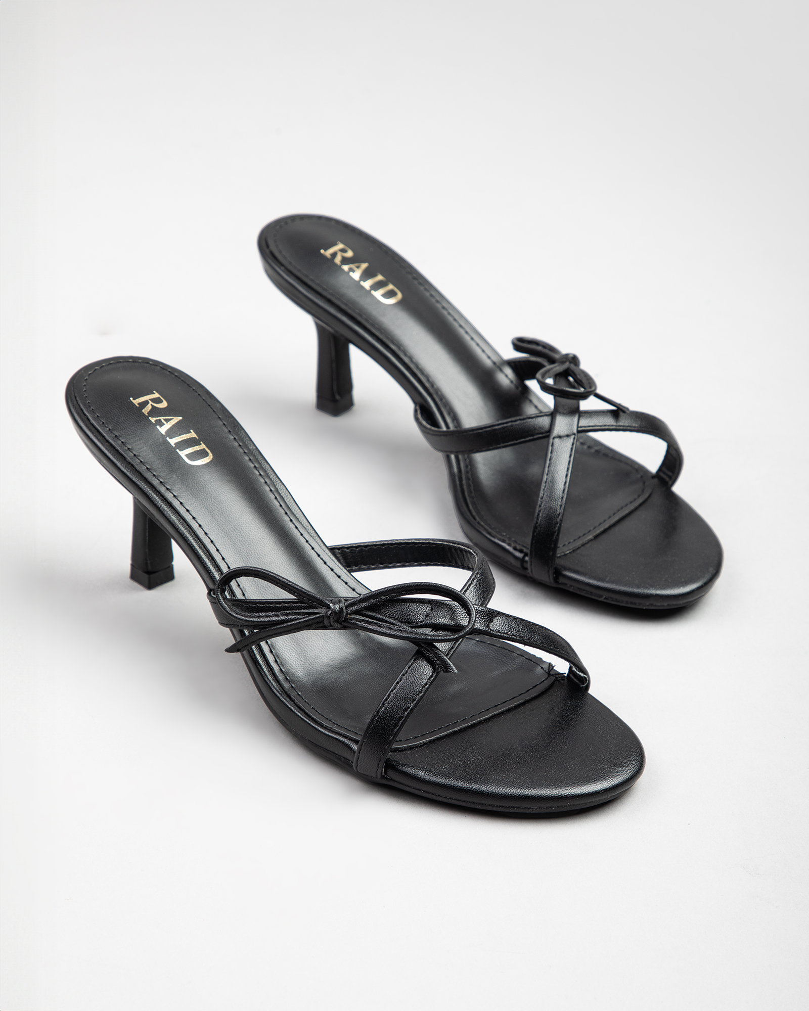 Ginni heeled mules with bow in Black